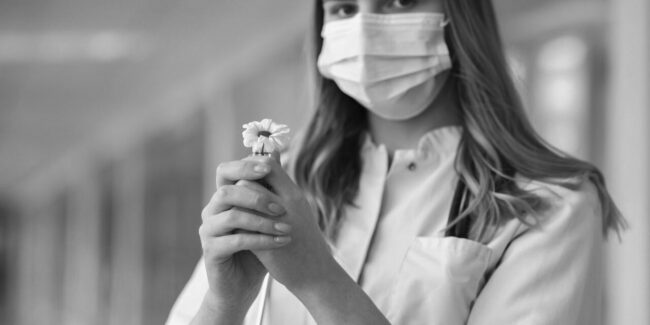 woman-in-white-button-up-shirt-with-white-face-mask-holding-3985156-1280×640